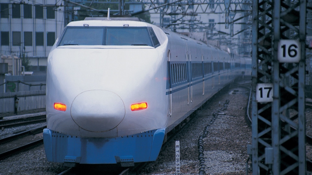 Bullet train traveling down track in Tokyo