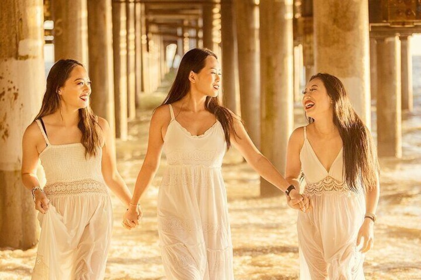 Three sisters from the midwest enjoying a spontaneous photoshoot under the Santa Monica Pier. I love the light under the pier during golden hour.