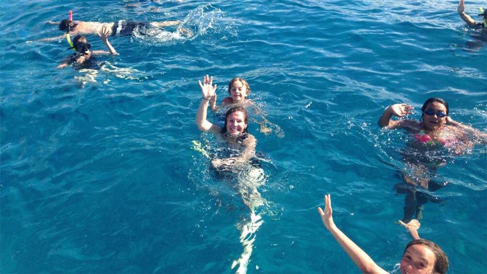 group of people swimming in water in Kauai