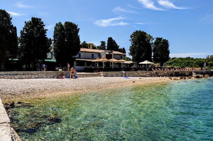 Beach and restaurant on St.Jerolim island. Depends in the weather - water ranges from turquoise to deep blue, but it is always crystal clear.