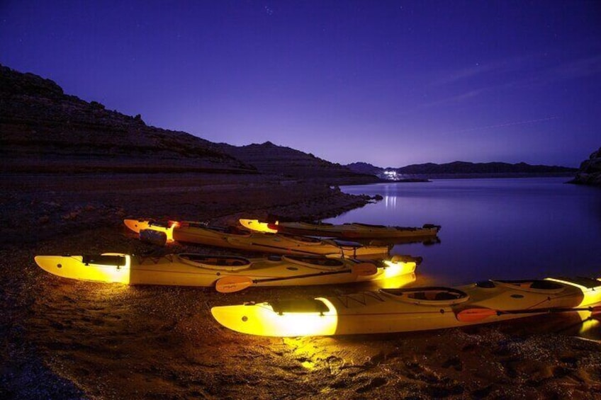 Kayaks lit up for a night time paddle from the Boulder Islands.