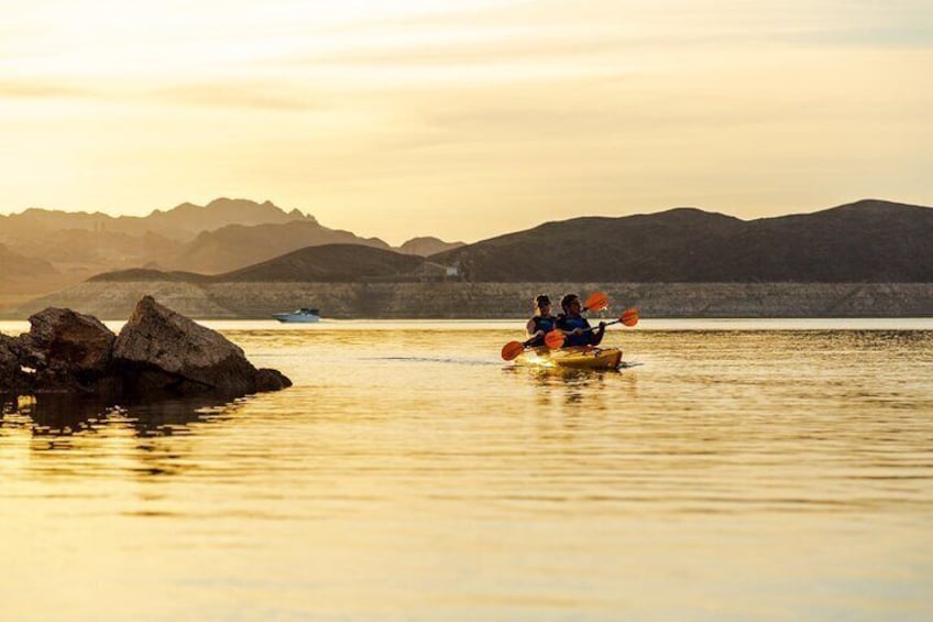 Two guests paddling around the Boulder Islands of Lake Mead at sun down.