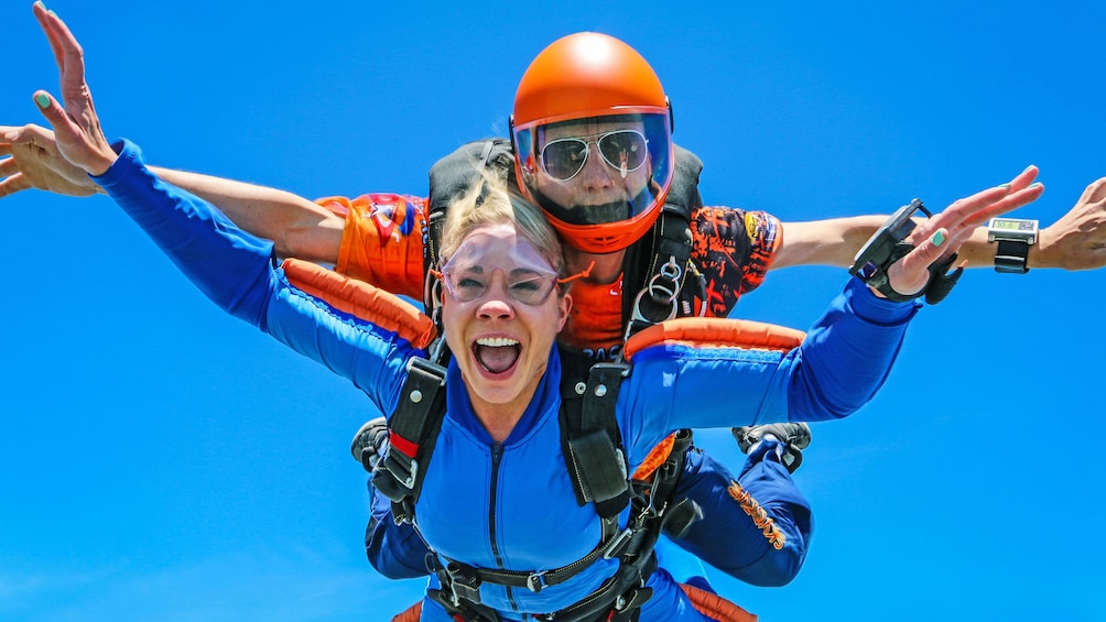 Show item 5 of 5. Woman skydiving with instructor over Atlanta