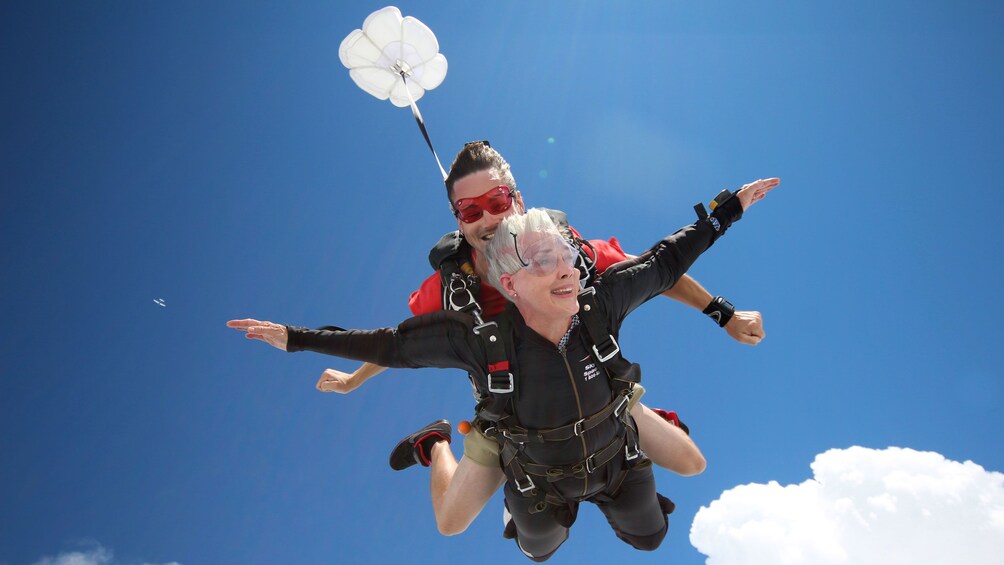 Show item 4 of 5. Woman skydiving with instructor over Atlanta