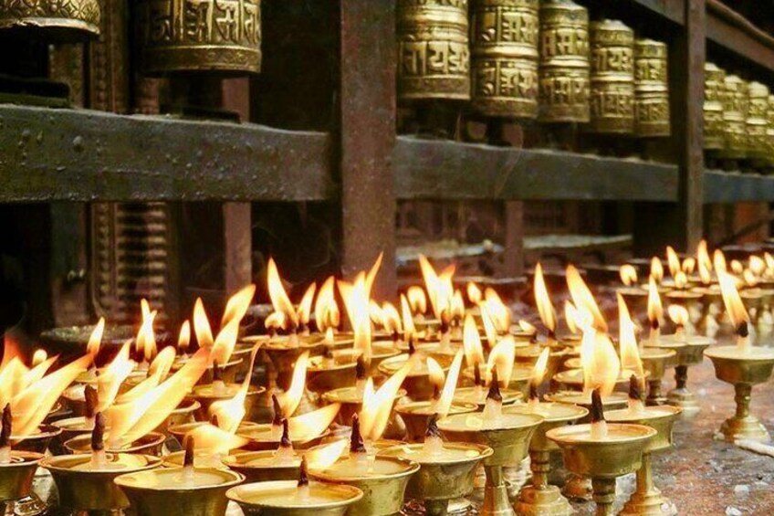 Butter lamps and prayer wheels used by Buddhist followers