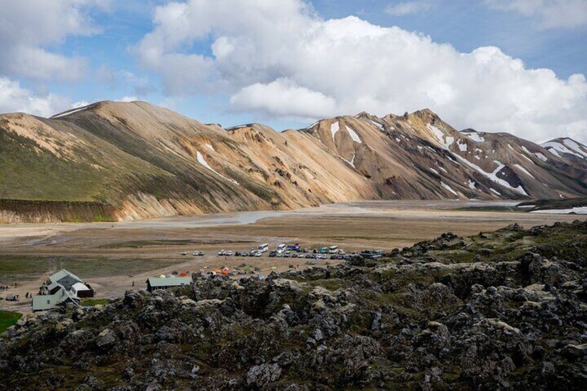 Standing on the lava field in Landmannalaugar looking over to the huts. The most characteristic mountain for landmannalaugar, Mt. Barmur in back.