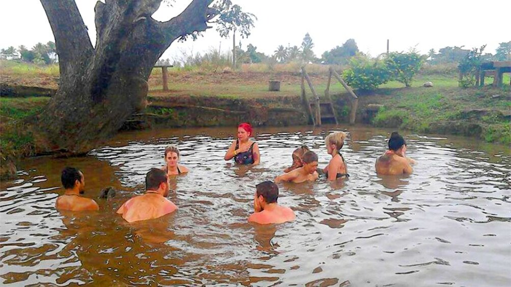 People in a mud pool in Fiji