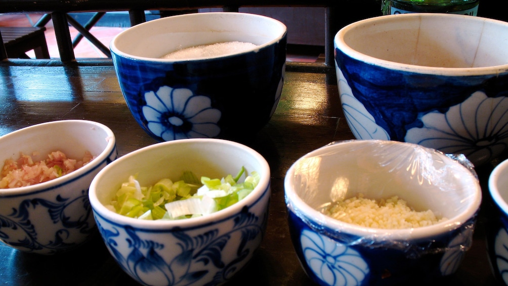 Bowls of ingredients on table for cooking class in Hanoi