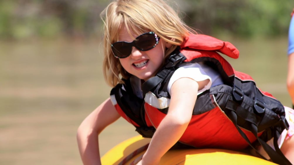 Young girl on a raft on a river in Utah