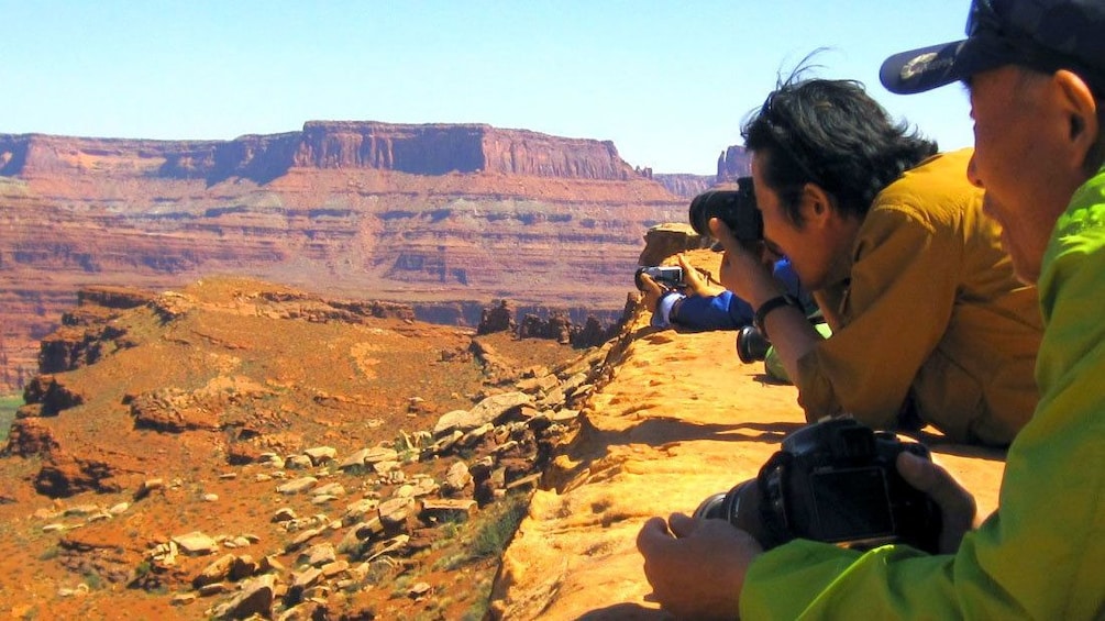Hiking group taking photos of Canyonlands National Park in Utah