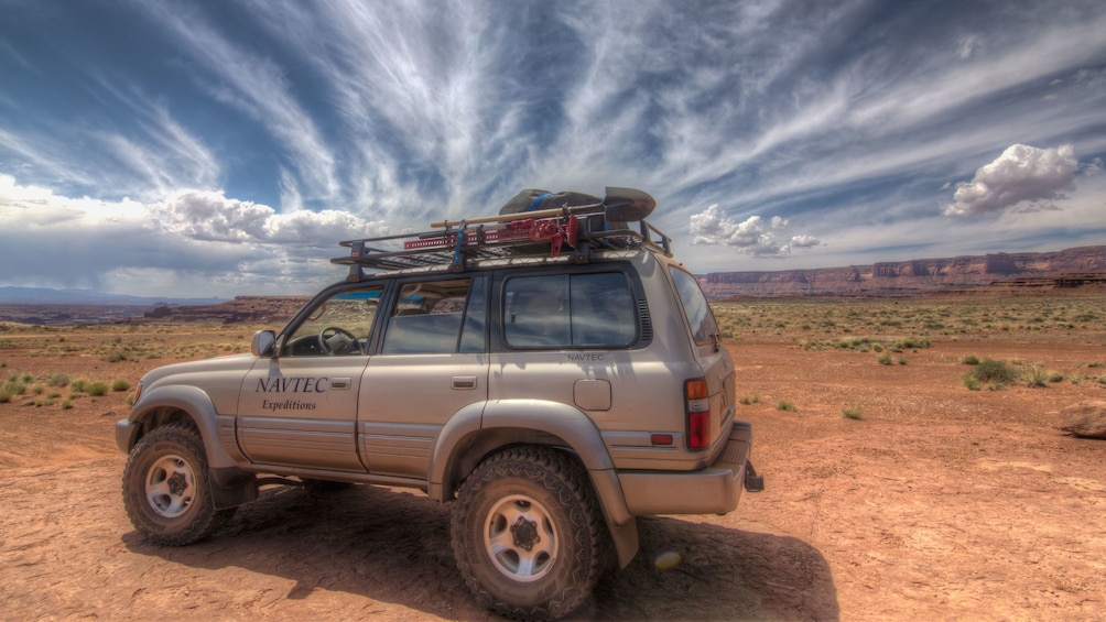 Tour vehicle with gear in Canyonlands
