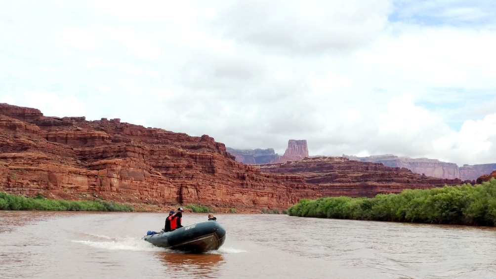 Boat cruising down river in Canyonlands