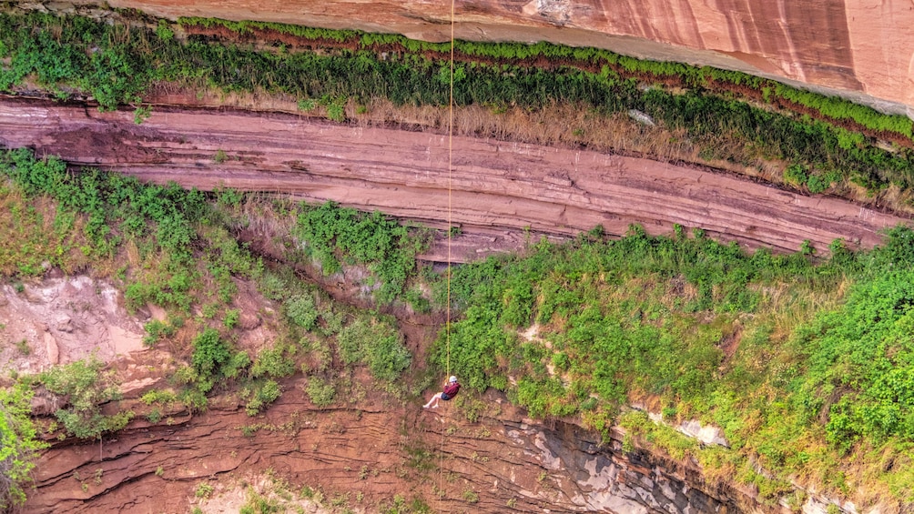 Person repelling down cliff face in Moab