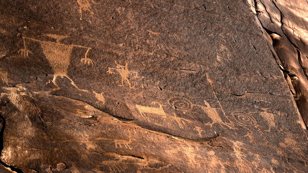 Petroglyphs of people and animals on rocks in White Rim, Moab