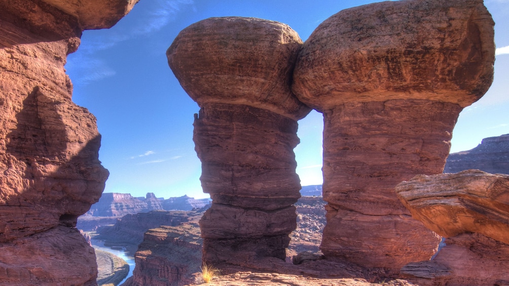 Standing rocking near cliff edge in White Rim, Moab