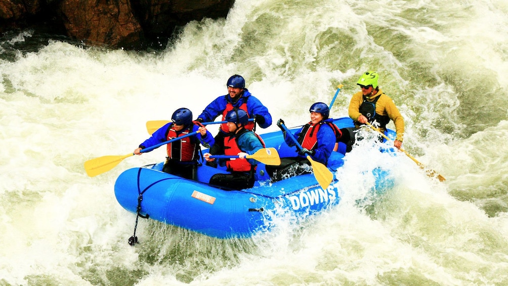 Show item 1 of 5. Rafters hitting rapids on Clear Creek with guide in Denver