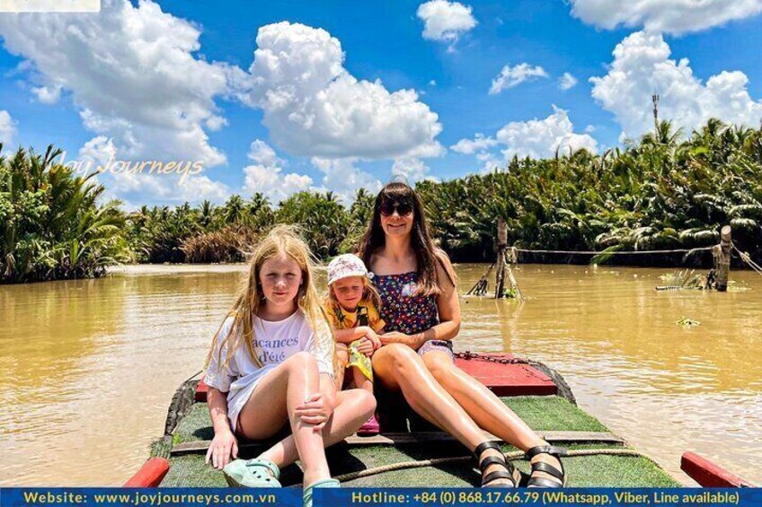 Family enjoyed the beautiful view and boat ride on Mekong River in Ben Tre