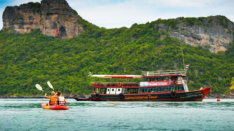 Women kayaking near a boat on Samui Island