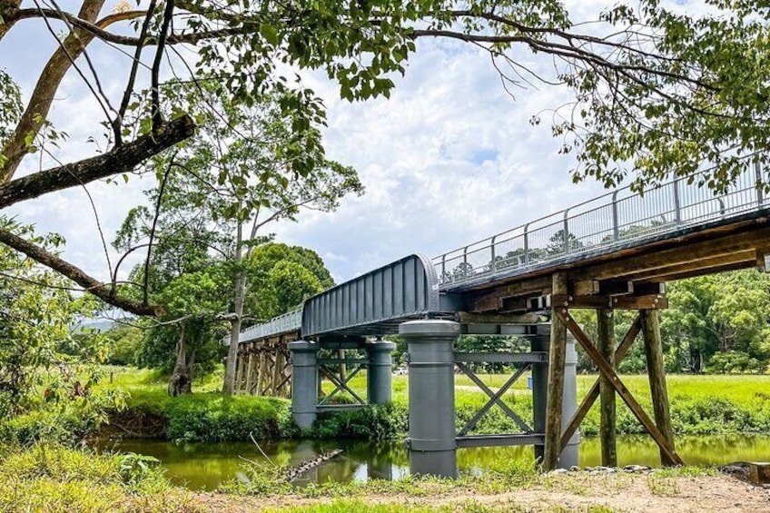 E Biking over Mills Creek Bridge in Mooball on the Northern Rivers Rail Trail