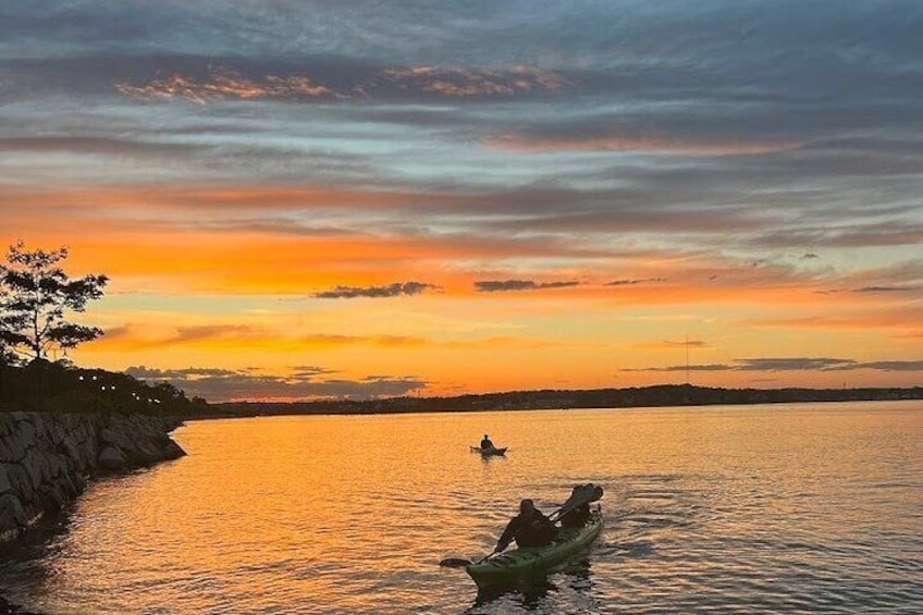 Paddling to shore at the end of a Sunset Kayak Tour