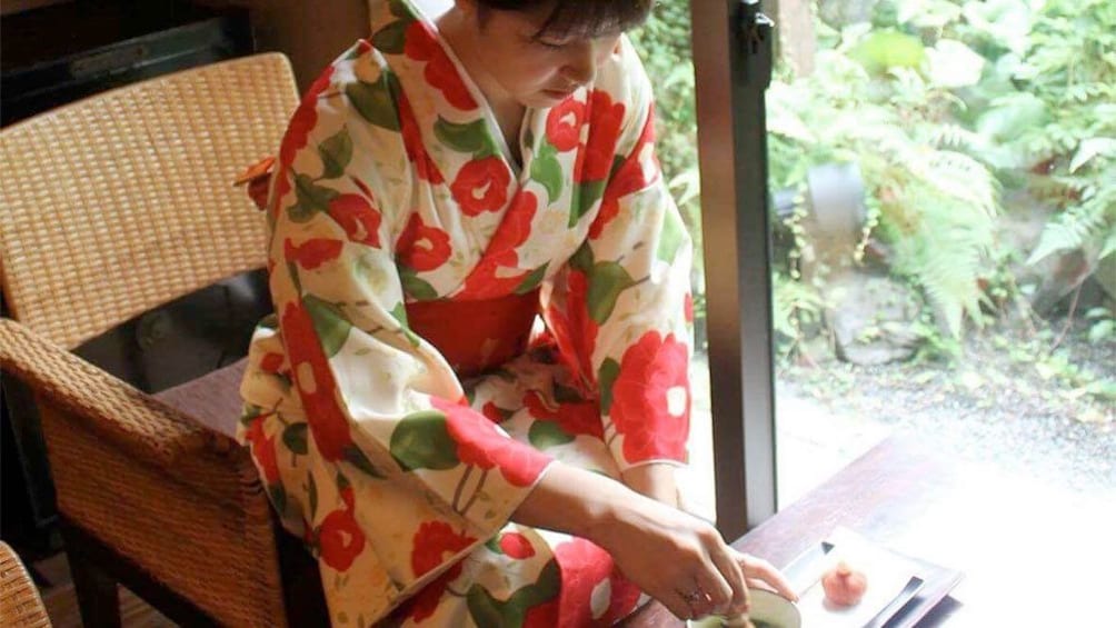 Show item 1 of 5. Woman on the Japanese tea ceremony experience in a kimono in Kyoto