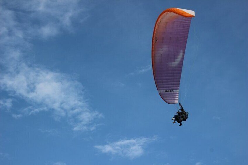 Paragliding flight over a valley of mountains and waterfalls + video