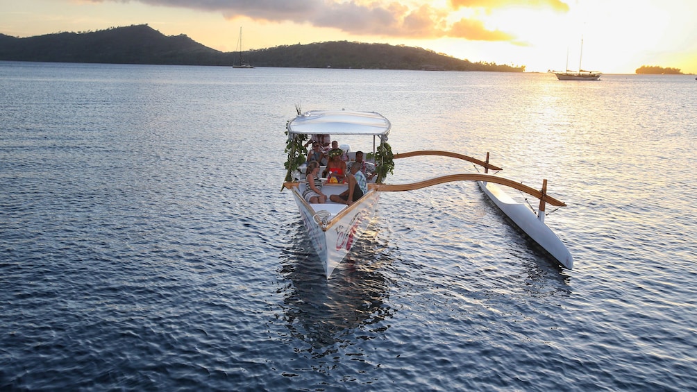 Show item 2 of 7. Sunset cruise boat making way to dock in Bora Bora