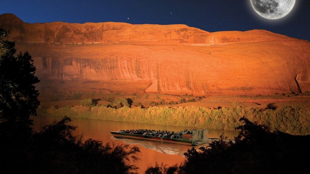 Show item 2 of 5. Night boat tour on a river in Utah with a fake moon