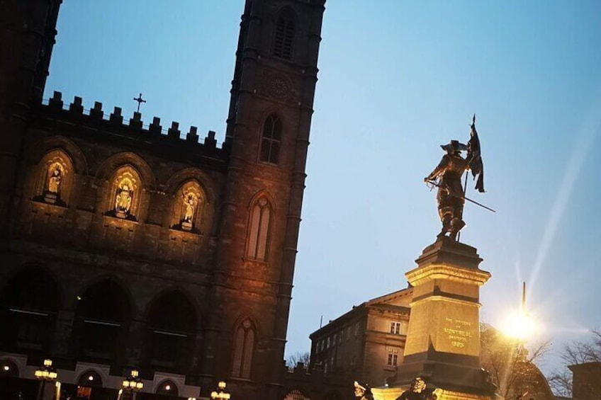 Place d'Armes and the Notre Dame Basilica at dusk walking tour with Ruby