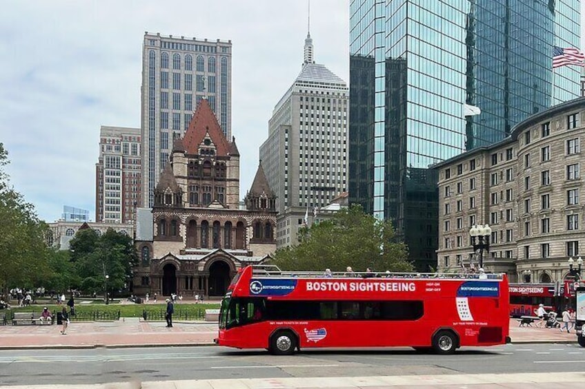 Boston Sightseeing Double-decker bus is in front of Trinity Church