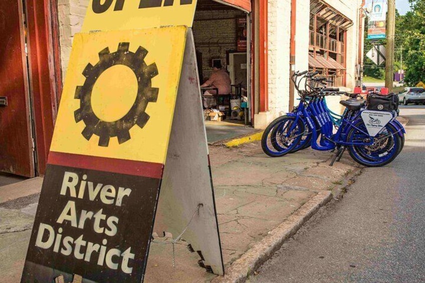 E-bikes parked in front of a gallery in the River Arts District