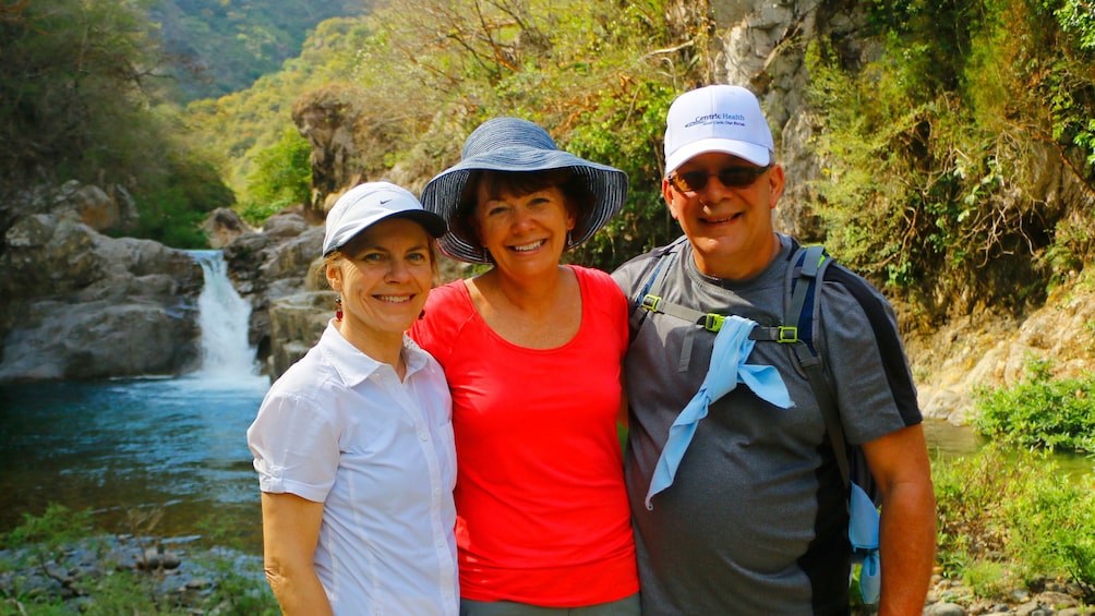 Hiking group through the woods and pool