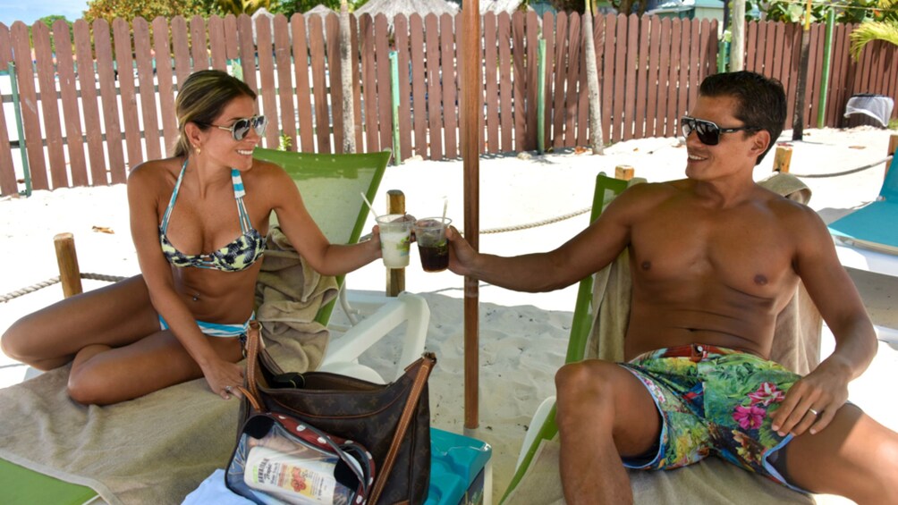 Couple enjoys drinks on a Jamaican beach