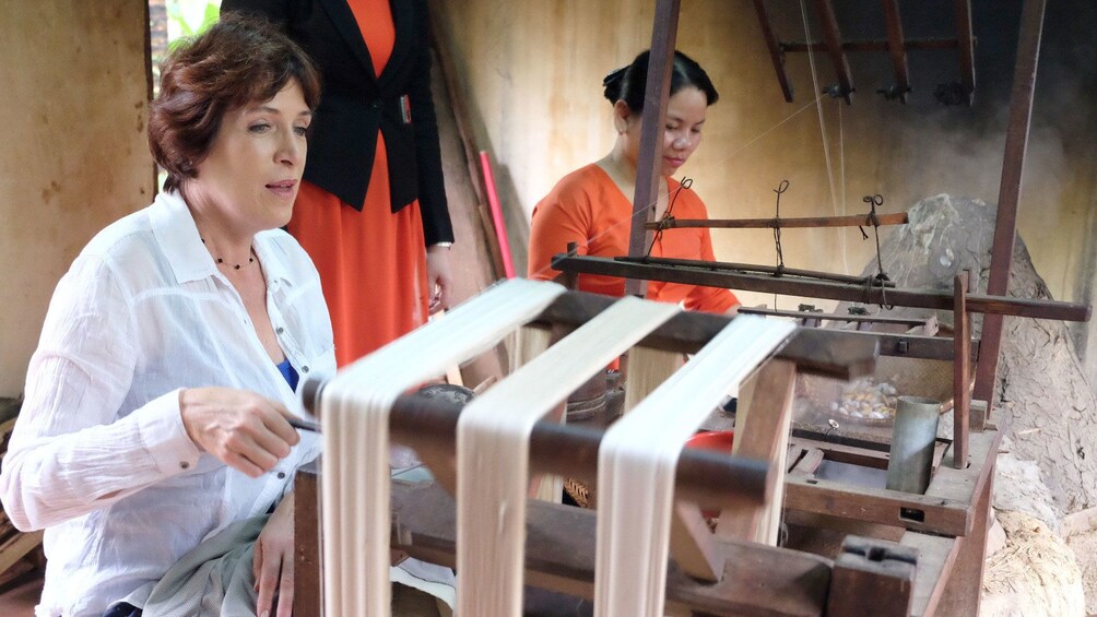 Women spin silk in Hoi An