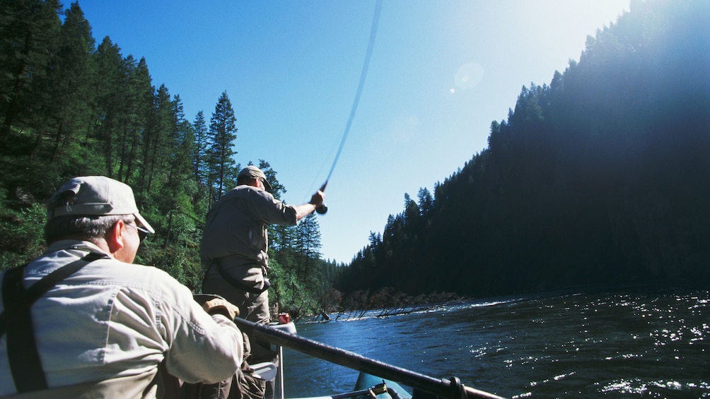 Two fishermen fishing from raft on river in Denali National Park