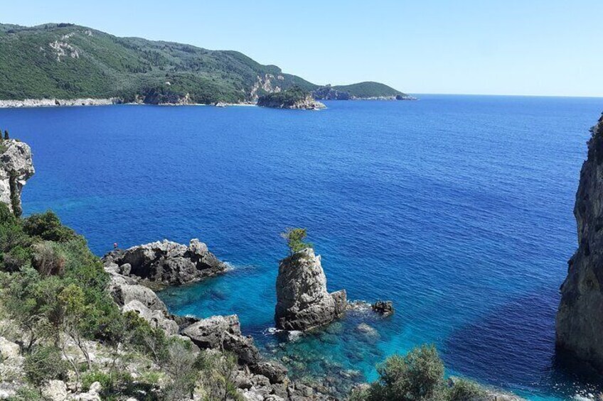 Beautiful cliffs and sea of Paleokastritsa Bay are some of the best spots to see during a half day tour in Corfu.