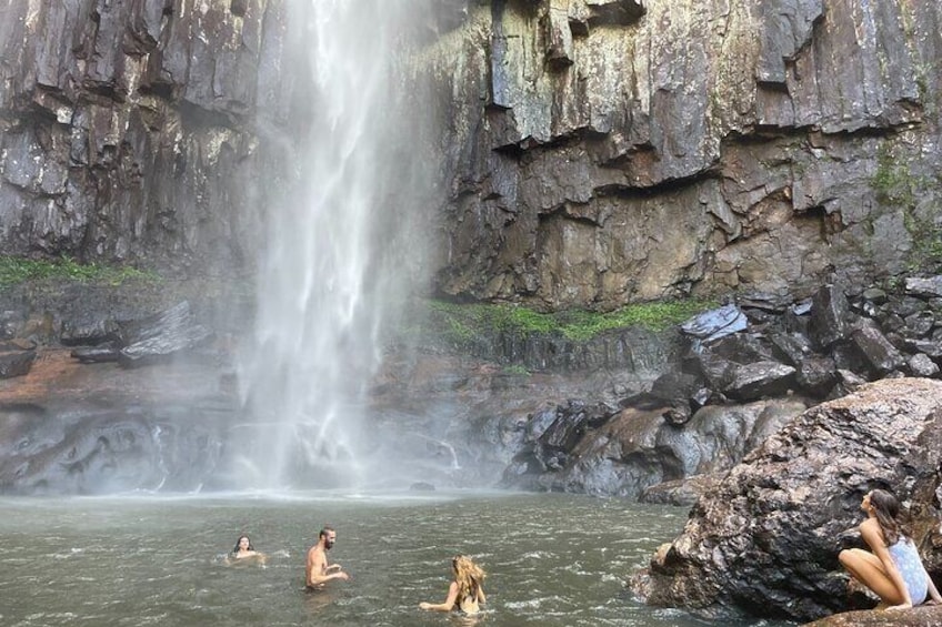Refreshing swim under the waterfall
