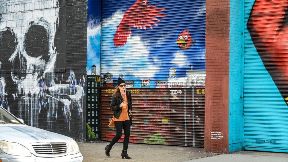 Woman walking on a graffiti-lined street in New York