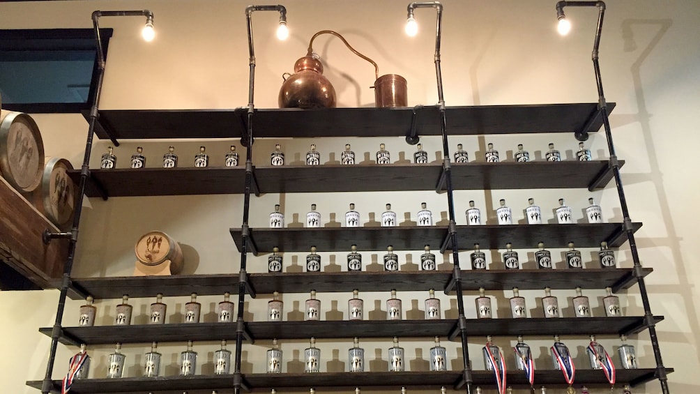 Show item 5 of 5. Shelves with bottles at a distillery in Tennessee