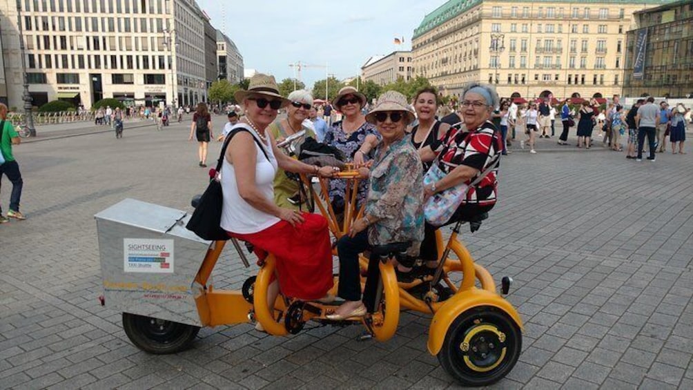 Happy customers from Mexico on one of our FunBikes / Teambikes / ConferenceBikes at Paris Square in front of Hotel Adlon.