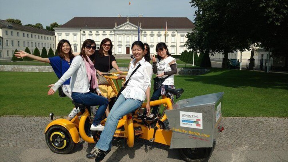 Happy customers from Japan on one of our FunBikes / Teambikes / ConferenceBikes in front of Palace Bellevue, Berlin.