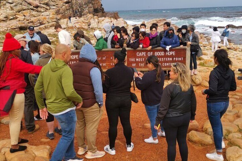 Memory picture taken by tourists at the cape of good hope board. 