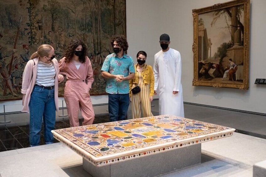 Discovering cultural treasures: Visitors captivated by Louvre Abu Dhabi's masterpieces.