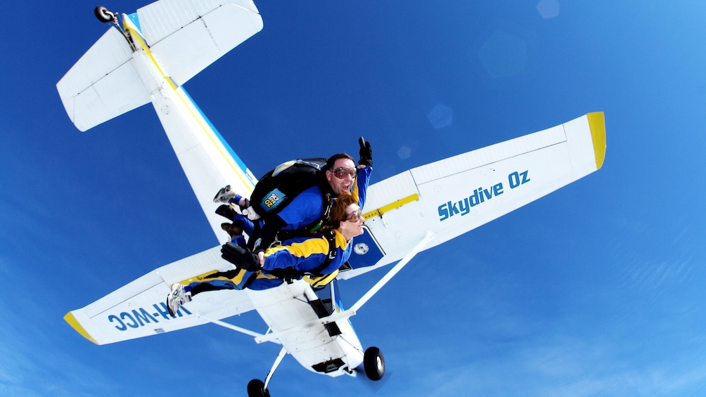 Tandem skydivers jumping from plane over Batemans Bay