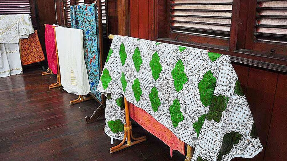 Textiles laid out on stands at textile museum in Bali