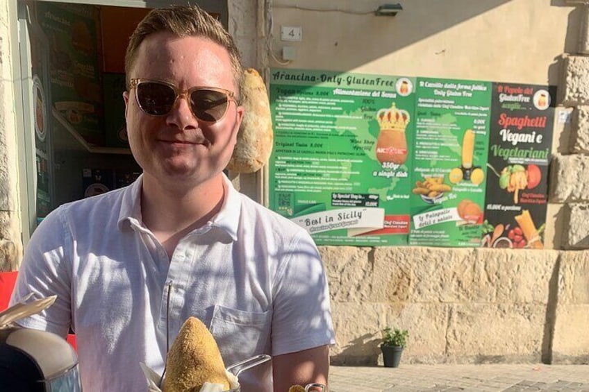 Thom enjoying the sun and fried rice balls!