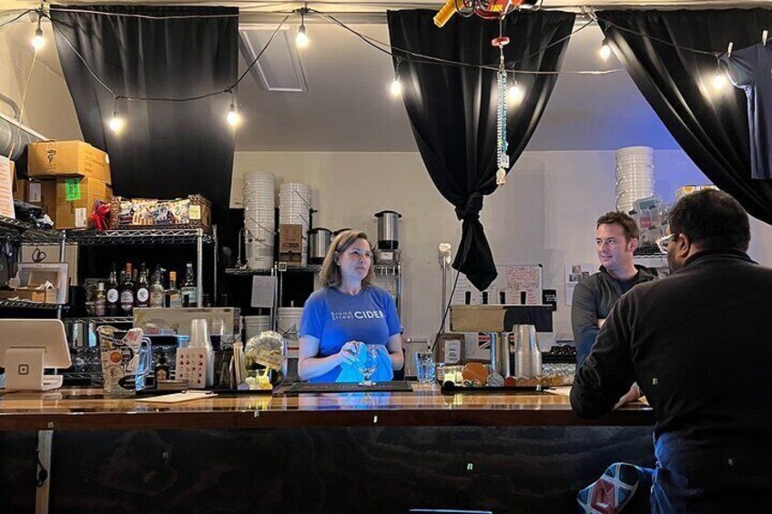 Jon & Diana at the bar, with our cidermaking area behind us