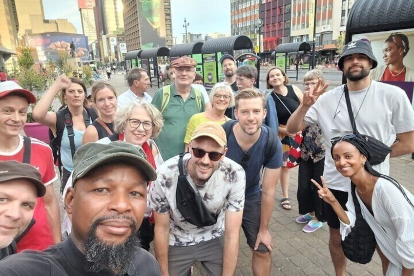 Charlie Moyo with tour group on Gandhi Square. 