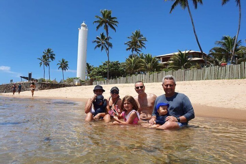 A family having fun in the warm and calm waters by the fort