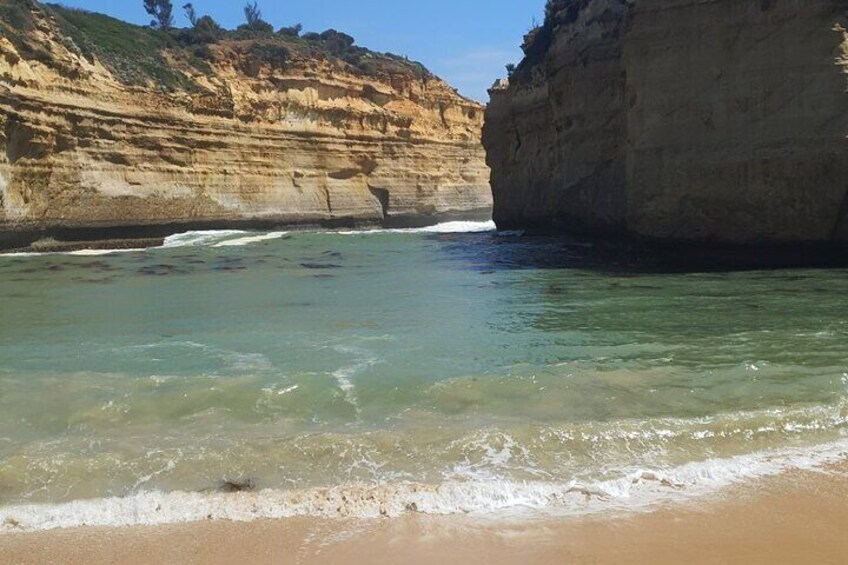 "Loch Ard Gorge" Enjoy a peaceful stroll along the sandy shores, hand in hand with the sound of crashing waves in the background. 